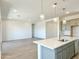 Open-concept living area connected to a kitchen, featuring neutral tones and natural light at 22685 E Saddle Way, Queen Creek, AZ 85142