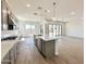 Spacious living room with direct kitchen access, modern lighting, and an open floor plan at 22685 E Saddle Way, Queen Creek, AZ 85142