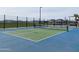 Community pickleball court with a green and blue surface with houses in background at 22685 E Saddle Way, Queen Creek, AZ 85142