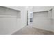 Carpeted walk-in closet features ample rod space for hanging clothes and access to the bathroom at 22685 E Saddle Way, Queen Creek, AZ 85142