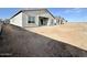 The exterior of a single-Gathering house with a view of the backyard with dirt at 22693 E Saddle Way, Queen Creek, AZ 85142