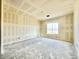 An unfinished bedroom is depicted with one large window bringing light to the room at 22693 E Saddle Way, Queen Creek, AZ 85142