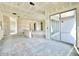 Open living area with drywall, large windows, and sliding glass doors leading to the backyard at 22693 E Saddle Way, Queen Creek, AZ 85142