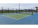 A community pickleball court on a sunny day with green and blue surfacing and chain link fencing at 22693 E Saddle Way, Queen Creek, AZ 85142