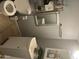 Cozy bathroom with decorative shelving, a toilet, and a sink at 2530 W Berridge Ln # E201, Phoenix, AZ 85017