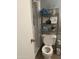 Functional bathroom featuring a toilet, walk-in shower and decorative shelving at 2530 W Berridge Ln # E201, Phoenix, AZ 85017