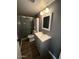 Well-lit bathroom featuring modern vanity, mirror, and shower at 2551 W Berridge Ln # D6, Phoenix, AZ 85017
