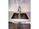 Close up of the kitchen sink and stainless steel faucet with subway tile backsplash at 2551 W Berridge Ln # D6, Phoenix, AZ 85017