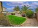 Backyard featuring a lawn, desert landscaping, privacy wall and covered patio at 2560 E Indian Wells Pl, Chandler, AZ 85249