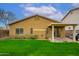 A backyard featuring a well-maintained lawn and covered patio at 2560 E Indian Wells Pl, Chandler, AZ 85249