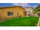 Backyard featuring a well-maintained lawn, desert landscaping, and covered patio at 2560 E Indian Wells Pl, Chandler, AZ 85249