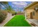 Green lawn with a covered patio and desert landscaping in the backyard at 2560 E Indian Wells Pl, Chandler, AZ 85249
