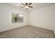 Bright bedroom with large window, neutral carpeting, and ceiling fan at 2560 E Indian Wells Pl, Chandler, AZ 85249