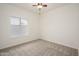 Carpeted bedroom featuring a window, ceiling fan and neutral color palette at 2560 E Indian Wells Pl, Chandler, AZ 85249