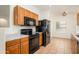 Functional kitchen with wooden cabinetry, and modern black appliances at 2560 E Indian Wells Pl, Chandler, AZ 85249
