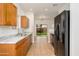 A view of the kitchen featuring wooden cabinetry, modern black appliances, and view to backyard at 2560 E Indian Wells Pl, Chandler, AZ 85249