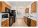 Functional kitchen with wooden cabinetry, and modern black appliances at 2560 E Indian Wells Pl, Chandler, AZ 85249