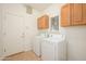 Laundry room featuring tile flooring, ample cabinet storage, and modern washer/dryer at 2560 E Indian Wells Pl, Chandler, AZ 85249