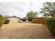 Spacious backyard area with desert landscaping and mature trees at 3125 E Grovers Ave, Phoenix, AZ 85032