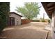 Sideyard space with storage shed, mature landscaping, and privacy fence at 3125 E Grovers Ave, Phoenix, AZ 85032