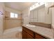 Bathroom featuring updated vanity, mirror, lighting, toilet, shower and tile surround at 3125 E Grovers Ave, Phoenix, AZ 85032