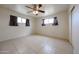 Large, bright bedroom with tile floors, ceiling fan, and ample natural light at 3125 E Grovers Ave, Phoenix, AZ 85032