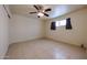 Spacious bedroom featuring neutral paint, a ceiling fan, tile floors and natural light at 3125 E Grovers Ave, Phoenix, AZ 85032
