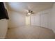 Spacious bedroom featuring neutral paint, closet doors, and tile floors at 3125 E Grovers Ave, Phoenix, AZ 85032