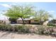 Charming single-story home featuring mature trees and flowering bushes in the front yard at 3125 E Grovers Ave, Phoenix, AZ 85032