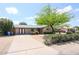 Inviting home showcasing a well-maintained front yard and a spacious concrete driveway at 3125 E Grovers Ave, Phoenix, AZ 85032