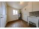 Utility room with washer and dryer hookups, sink, window, and door at 3125 E Grovers Ave, Phoenix, AZ 85032