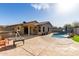 Backyard with pool, outdoor kitchen, desert landscaping, covered patio, and exterior view of the residence at 33224 N Cat Hills Ave, San Tan Valley, AZ 85144