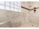 Elegant bathroom features a tiled walk-in shower with glass block window for privacy at 33224 N Cat Hills Ave, San Tan Valley, AZ 85144