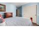 Light blue bedroom with wooden furniture and closet at 33224 N Cat Hills Ave, San Tan Valley, AZ 85144
