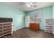 Bedroom with wood-look tile flooring, ceiling fan, and a window with natural light at 33224 N Cat Hills Ave, San Tan Valley, AZ 85144