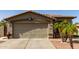 Exterior of a single-Gathering house featuring a two-car garage, desert landscaping, and tiled roof at 33224 N Cat Hills Ave, San Tan Valley, AZ 85144