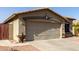 Image presenting a two-car garage with desert landscaping, a tiled roof, and a decorative sunburst above at 33224 N Cat Hills Ave, San Tan Valley, AZ 85144