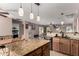 Open concept kitchen with granite island flows seamlessly into dining and living areas at 33224 N Cat Hills Ave, San Tan Valley, AZ 85144