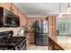 Well-equipped kitchen features granite counters, stainless appliances, and tile backsplash at 33224 N Cat Hills Ave, San Tan Valley, AZ 85144