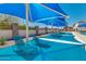 Resort-style pool area offers shaded lounge seating, perfect for relaxing poolside at 33224 N Cat Hills Ave, San Tan Valley, AZ 85144