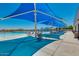 An inviting pool area with shade coverings, lounge chairs, and tables for relaxation at 33224 N Cat Hills Ave, San Tan Valley, AZ 85144