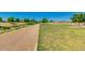 Scenic walking trail meanders through lush green spaces, perfect for outdoor exercise at 33224 N Cat Hills Ave, San Tan Valley, AZ 85144