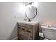 Bathroom featuring a wooden vanity with a white countertop and a decorative mirror at 3520 E Ludlow Dr, Phoenix, AZ 85032