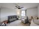 Cozy bedroom with ceiling fan and a rocking chair at 3520 E Ludlow Dr, Phoenix, AZ 85032