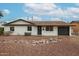 Charming single-story home with a well-maintained front yard and a tidy rock garden feature at 3520 E Ludlow Dr, Phoenix, AZ 85032