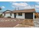 Charming single-story home with a well-maintained front yard and a tidy rock garden feature at 3520 E Ludlow Dr, Phoenix, AZ 85032
