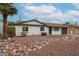 Charming single-story home with a well-maintained front yard and a tidy rock garden feature at 3520 E Ludlow Dr, Phoenix, AZ 85032