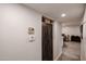 Bright hallway with a dark wood cabinet, tile floors, and access to other rooms at 3520 E Ludlow Dr, Phoenix, AZ 85032