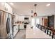 Open kitchen features a large island, stainless steel appliances, and modern lighting at 3520 E Ludlow Dr, Phoenix, AZ 85032