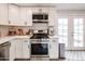 Modern kitchen featuring white cabinets, stainless steel appliances, and bright lighting fixtures at 3520 E Ludlow Dr, Phoenix, AZ 85032